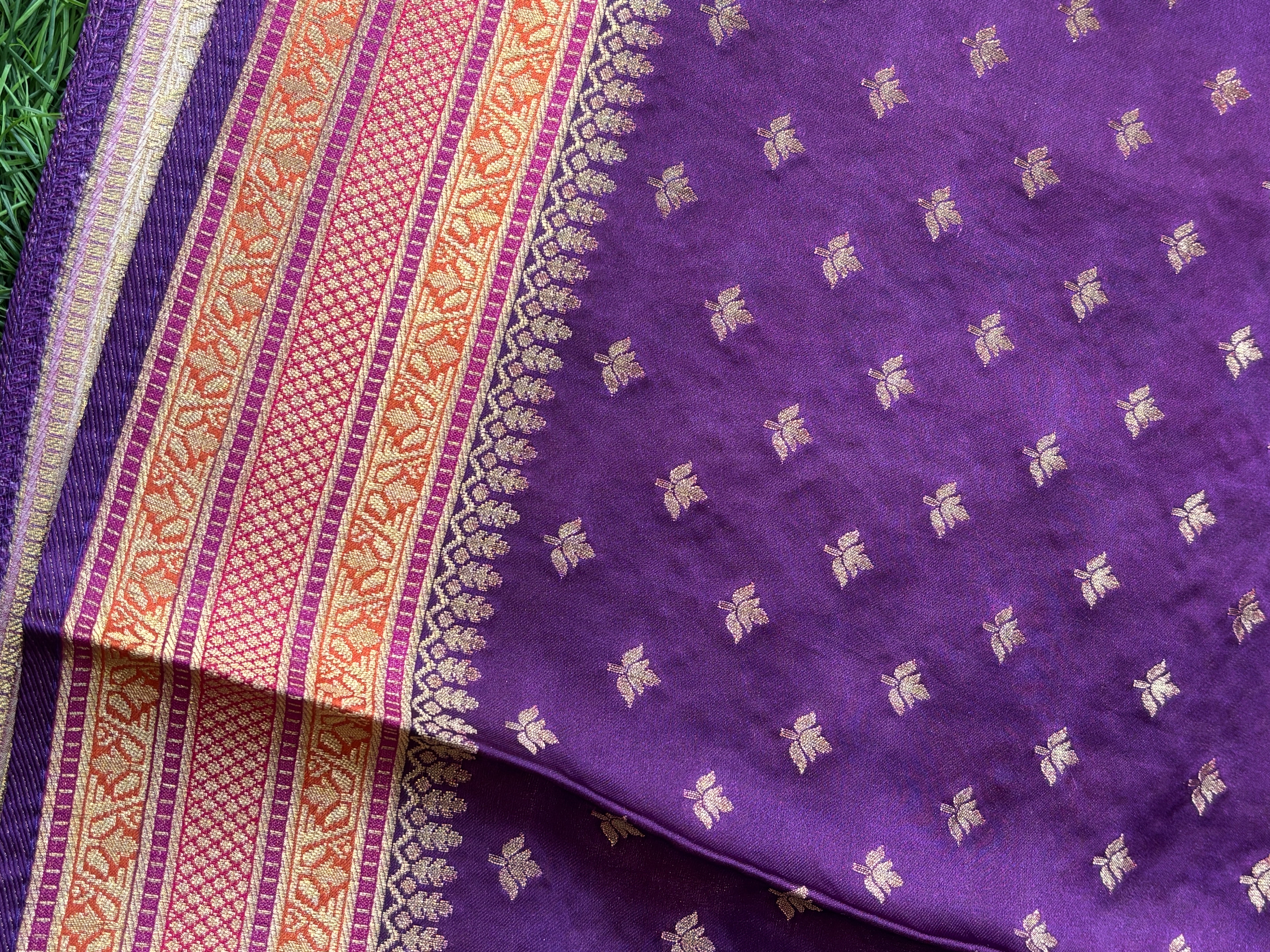 Dark purple contrast blouse with zari border paired with mango yellow Banarasi saree