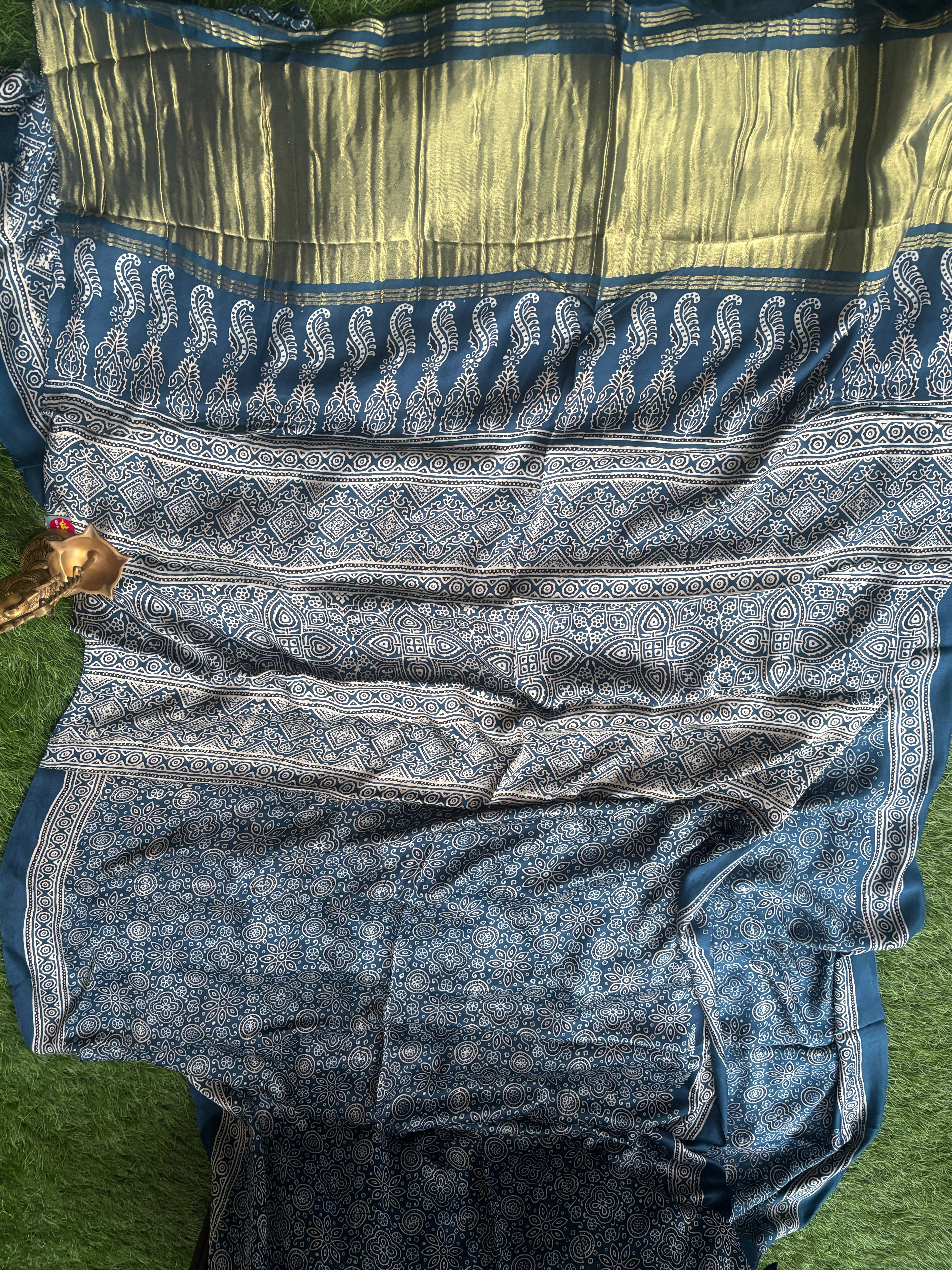 Detailed zari woven pallu of navy blue modal silk gharchola saree