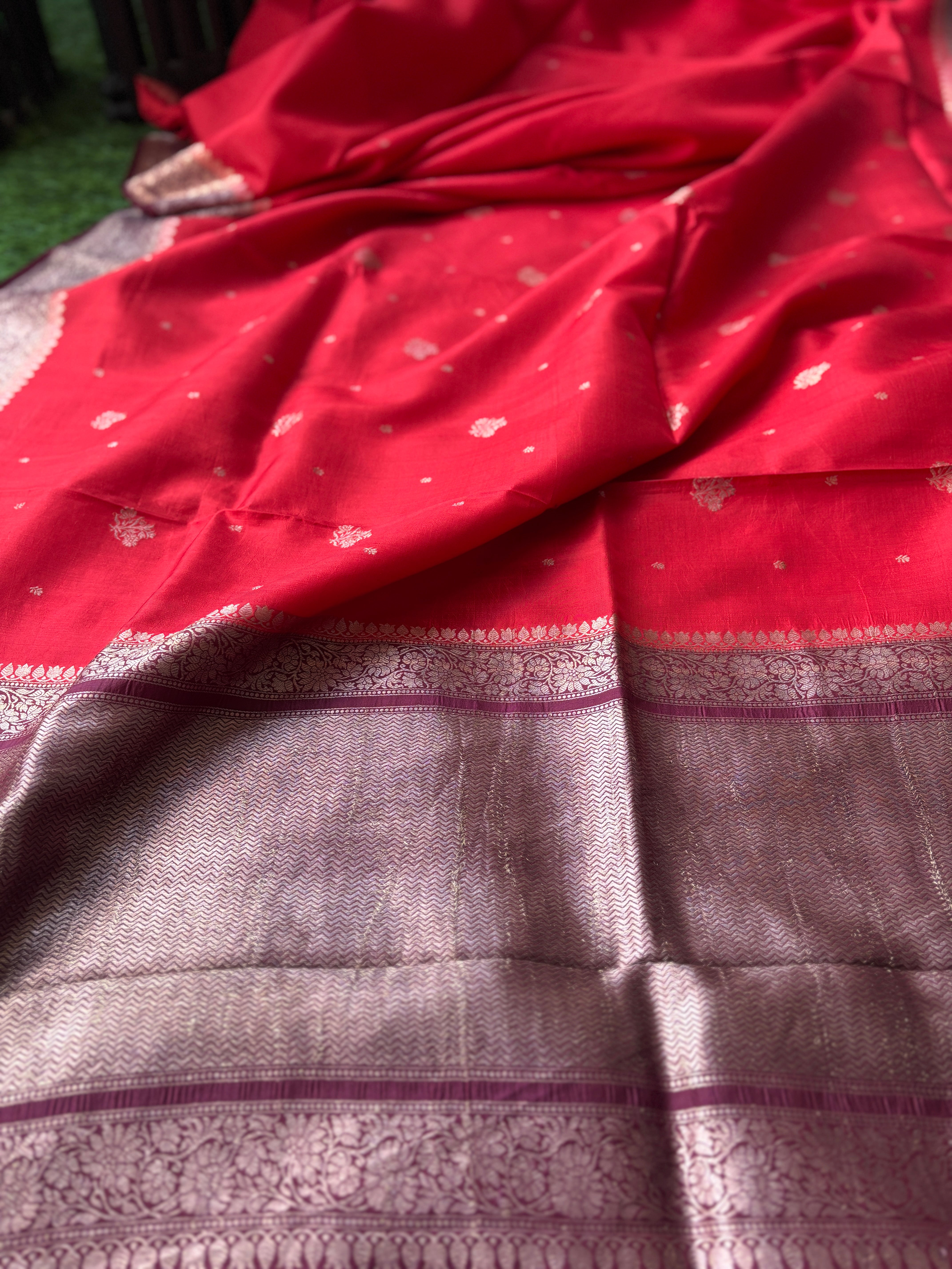 Luxurious smooth texture of pure silk fabric with traditional Banarasi weave