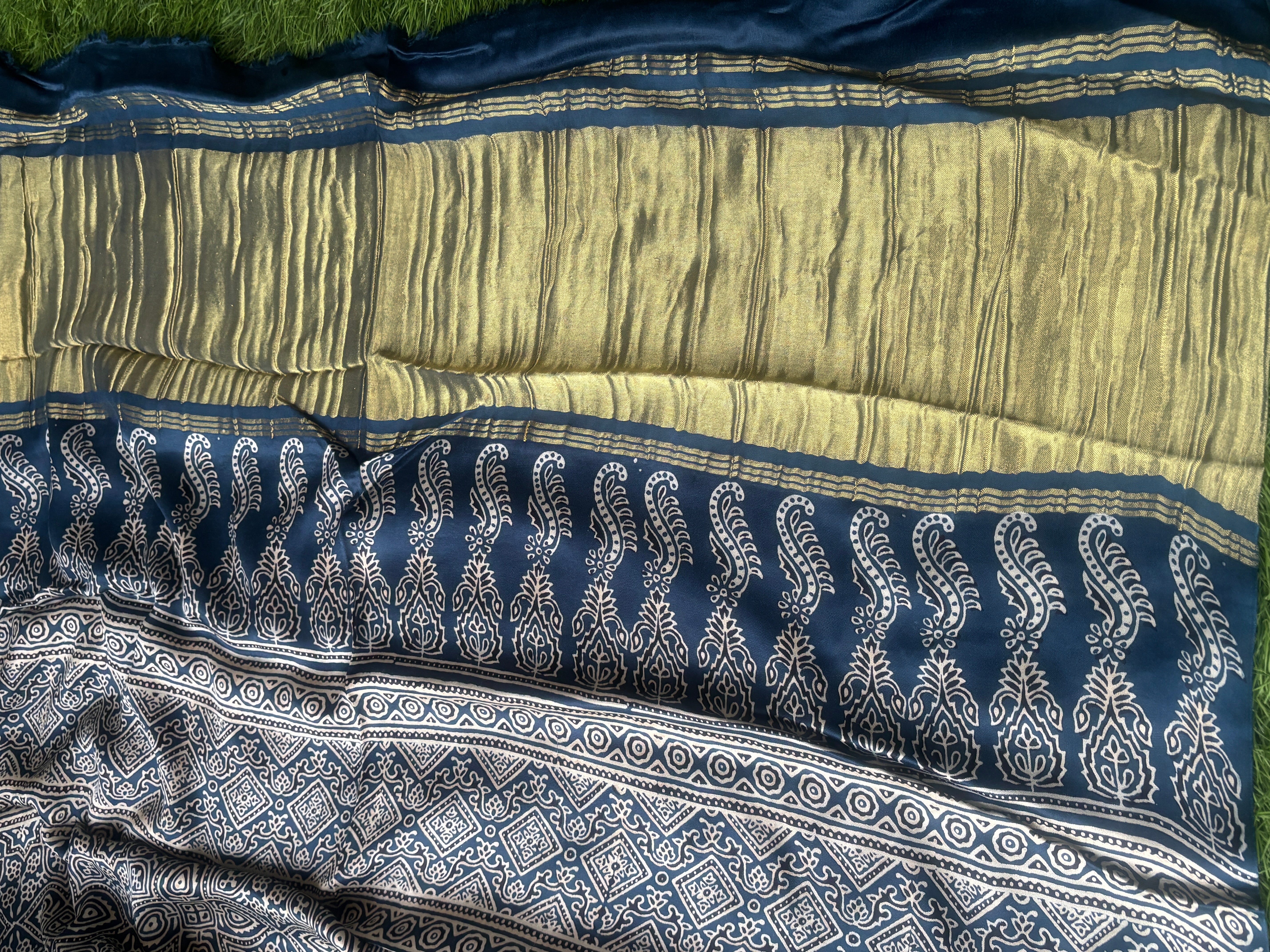 Detailed zari woven pallu of navy blue modal silk gharchola saree