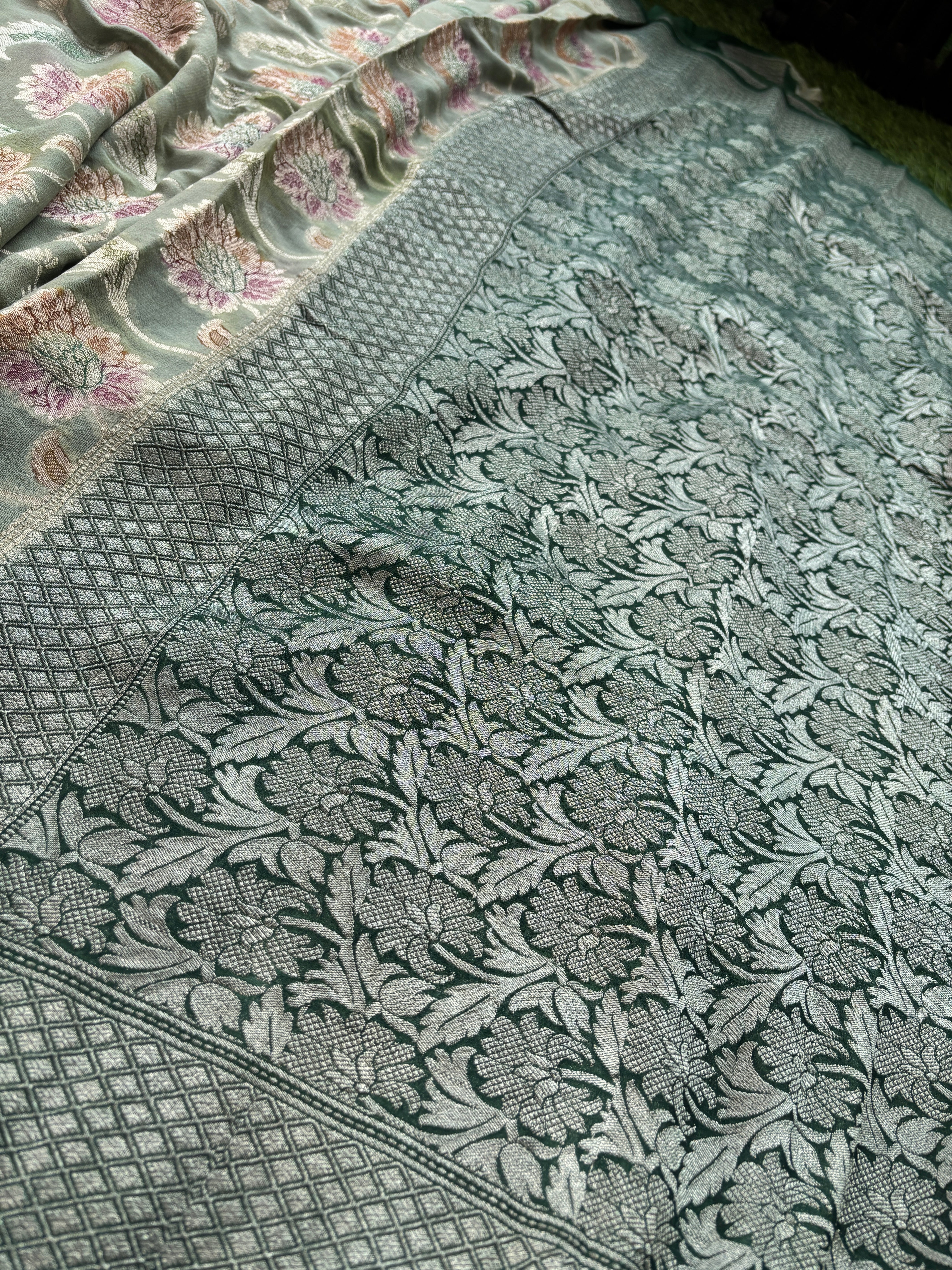 close-up of intricate gold zari motifs on pastel pista green fabric