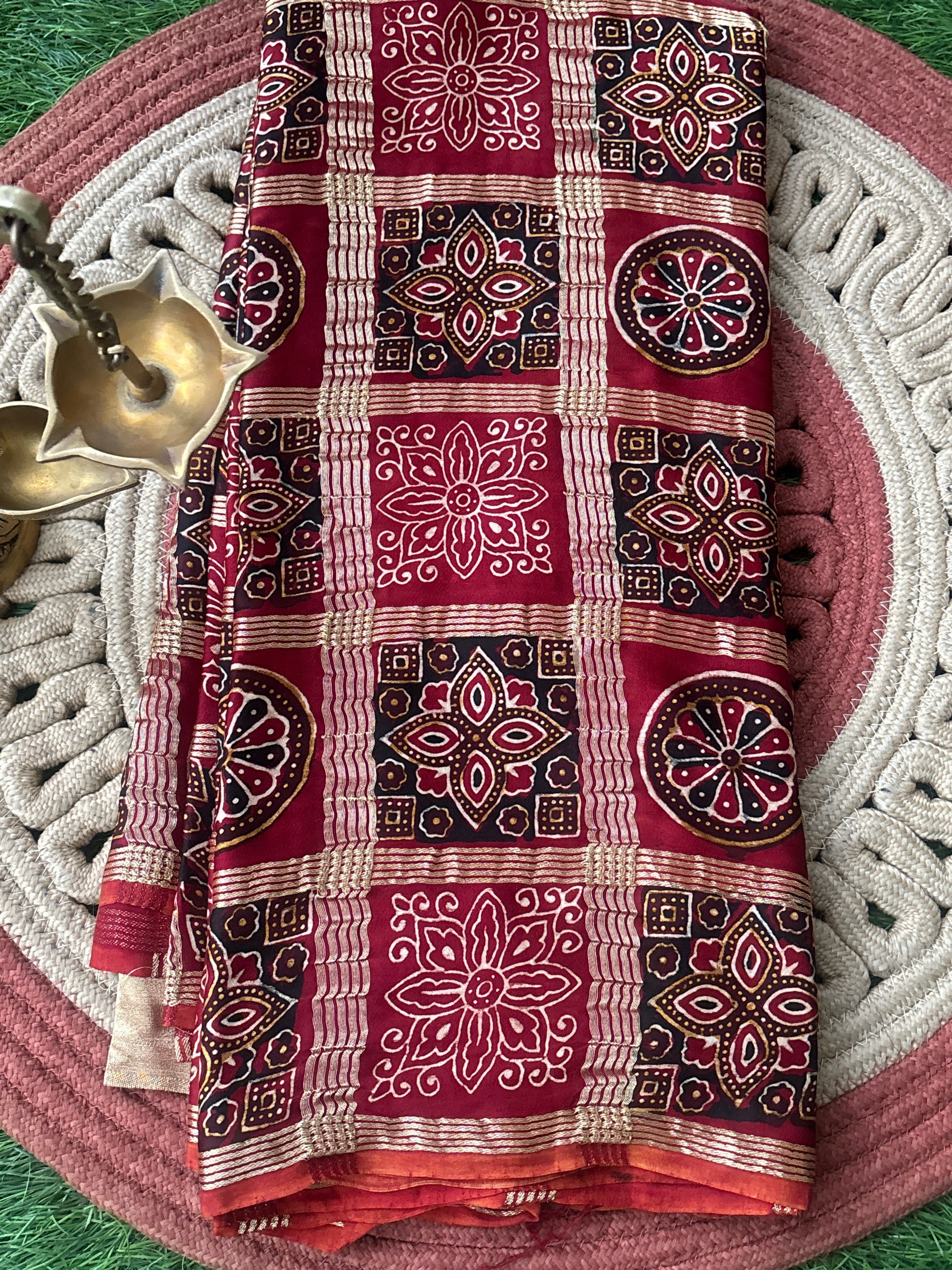 Red Pure Modal Silk Gharchola Saree with golden checks and zari pallu neatly draped