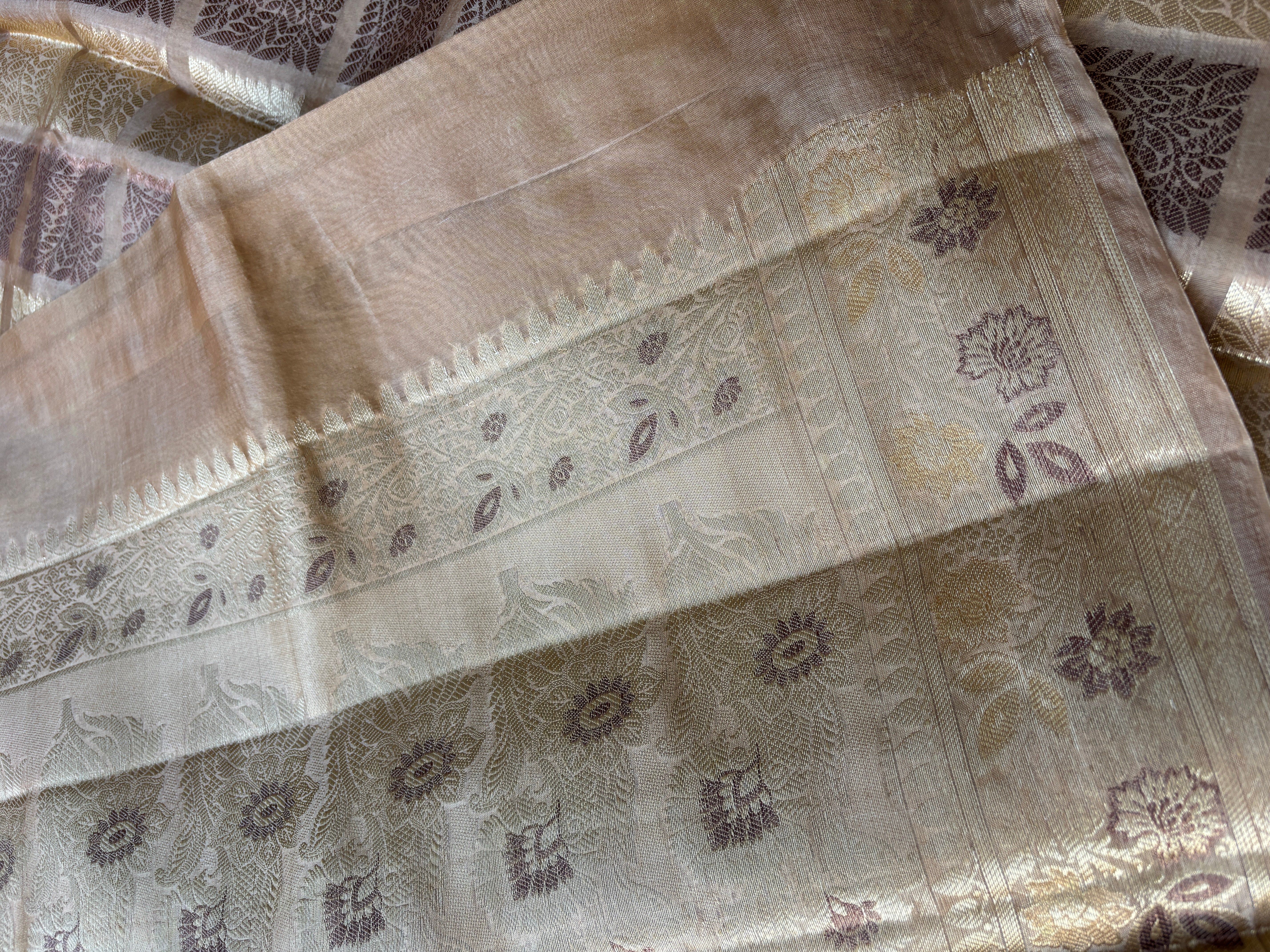 Brown contrast blouse with zari border paired with beige Banarasi saree