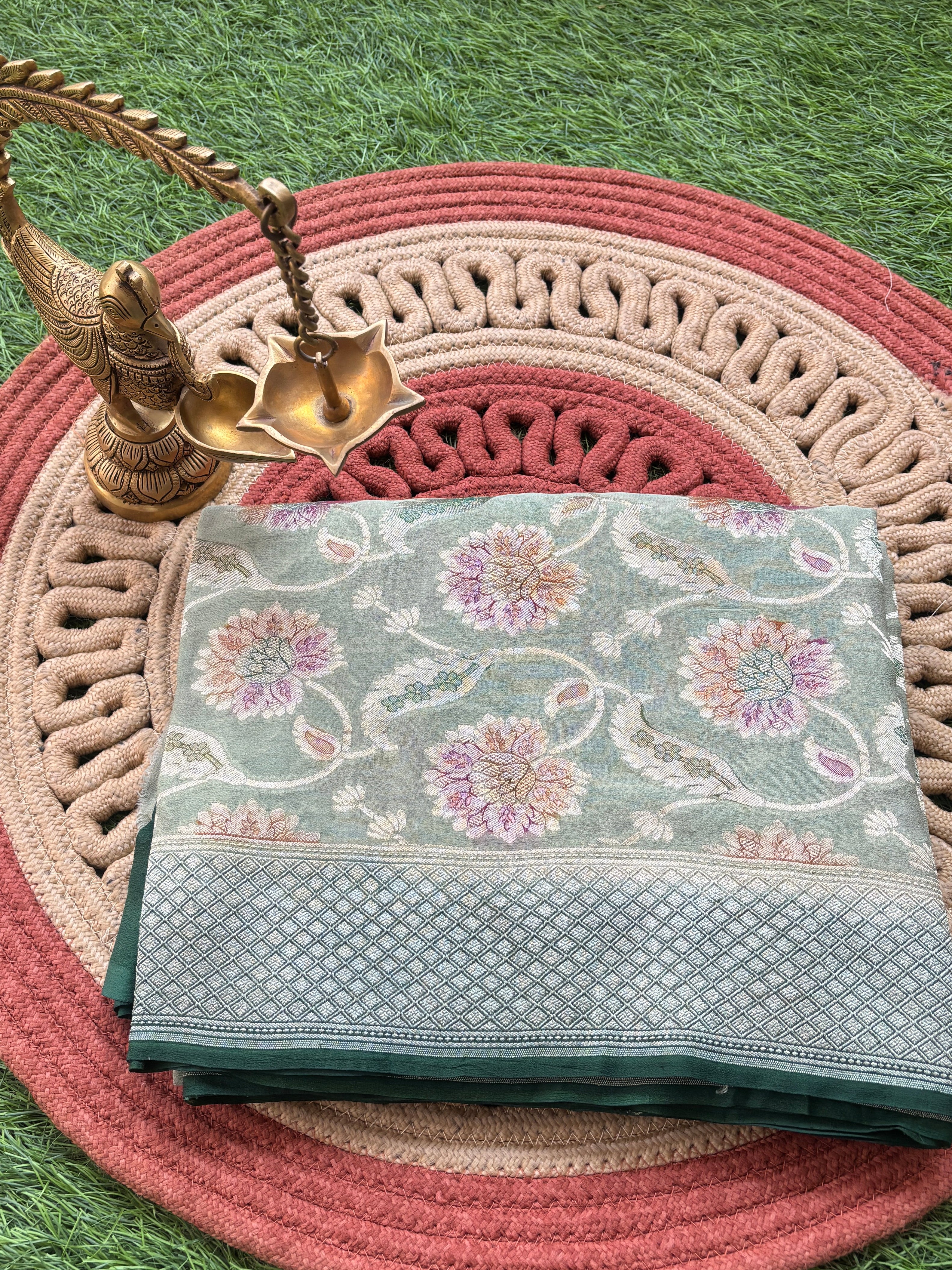 Pure khaddi georgette Banarasi saree in pastel pista green with zari weaving