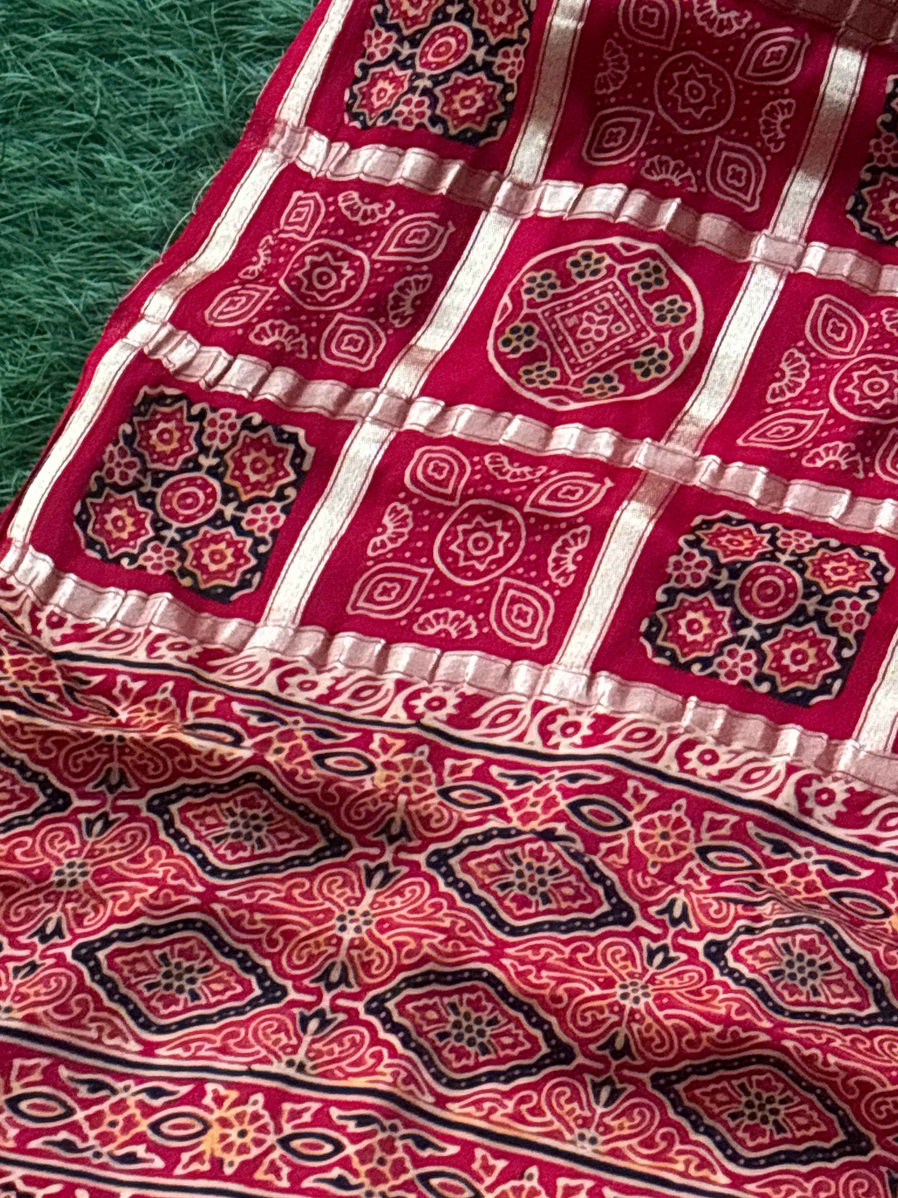 Close-up of Ajrakh print motifs with traditional Gharchola grid design