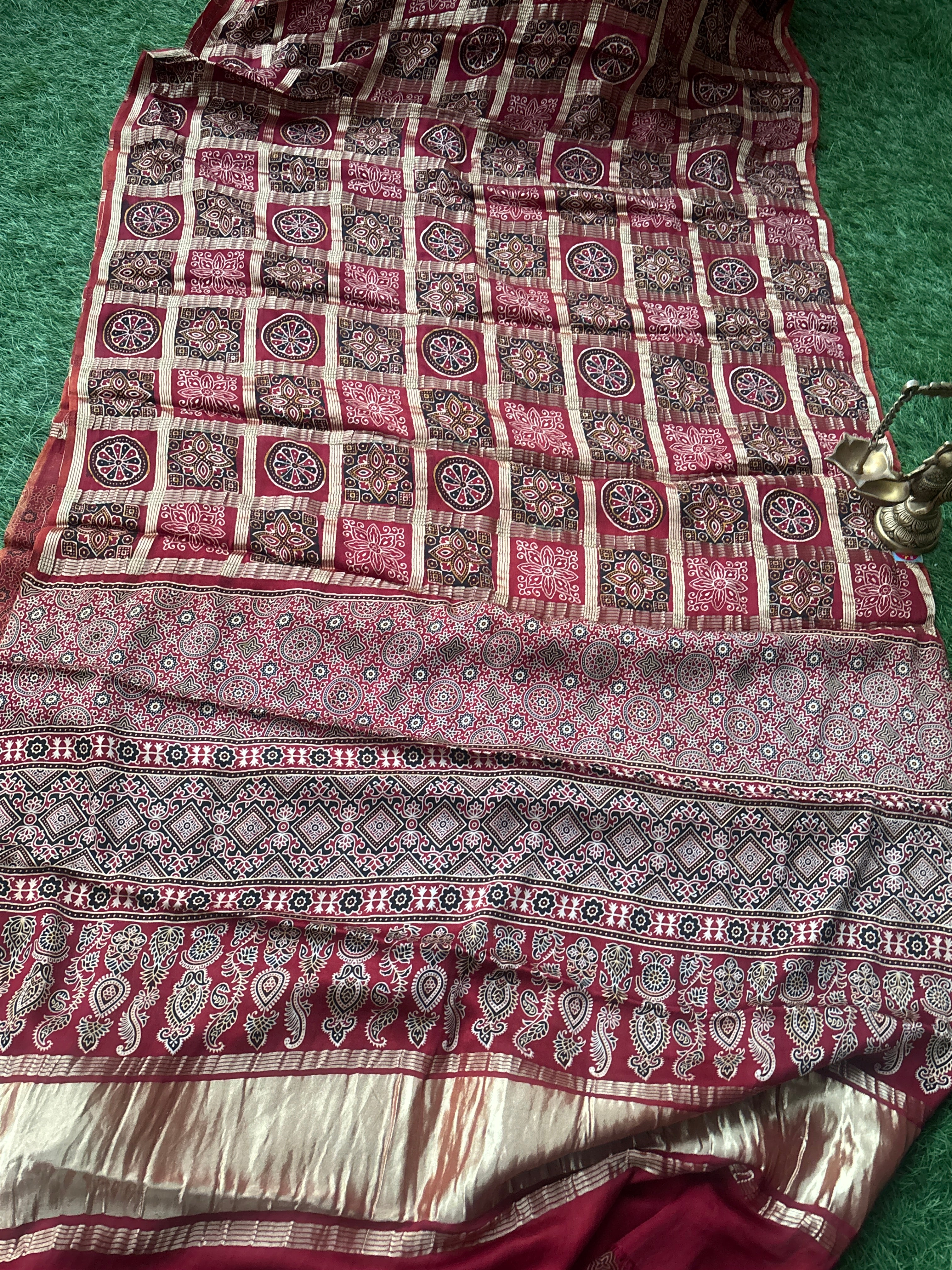 Zari woven pallu of Red Pure Modal Silk Gharchola Saree, showing intricate golden motifs