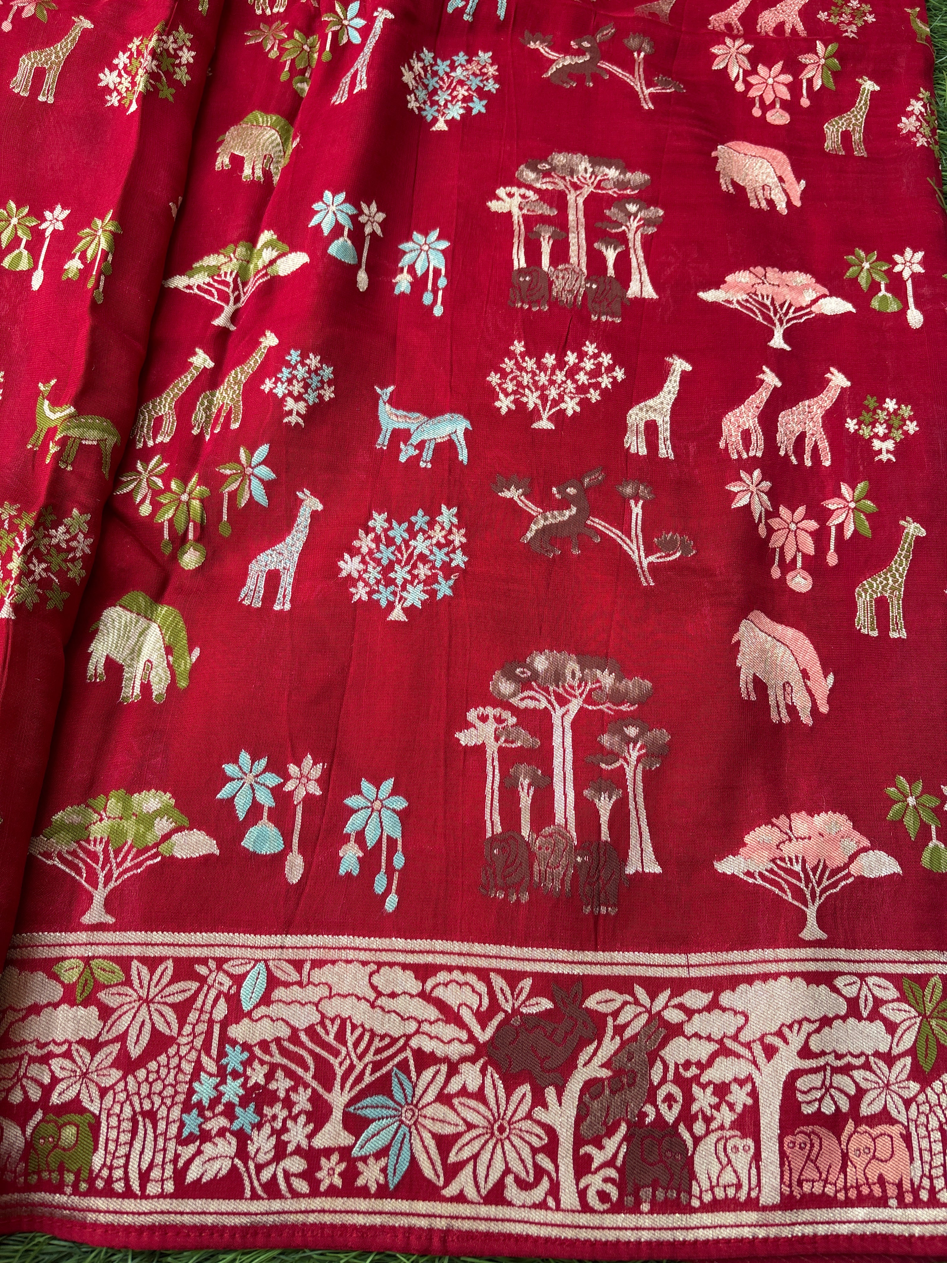 Blood red saree with intricate gold, green, and white patterns , animals figure with zari work .