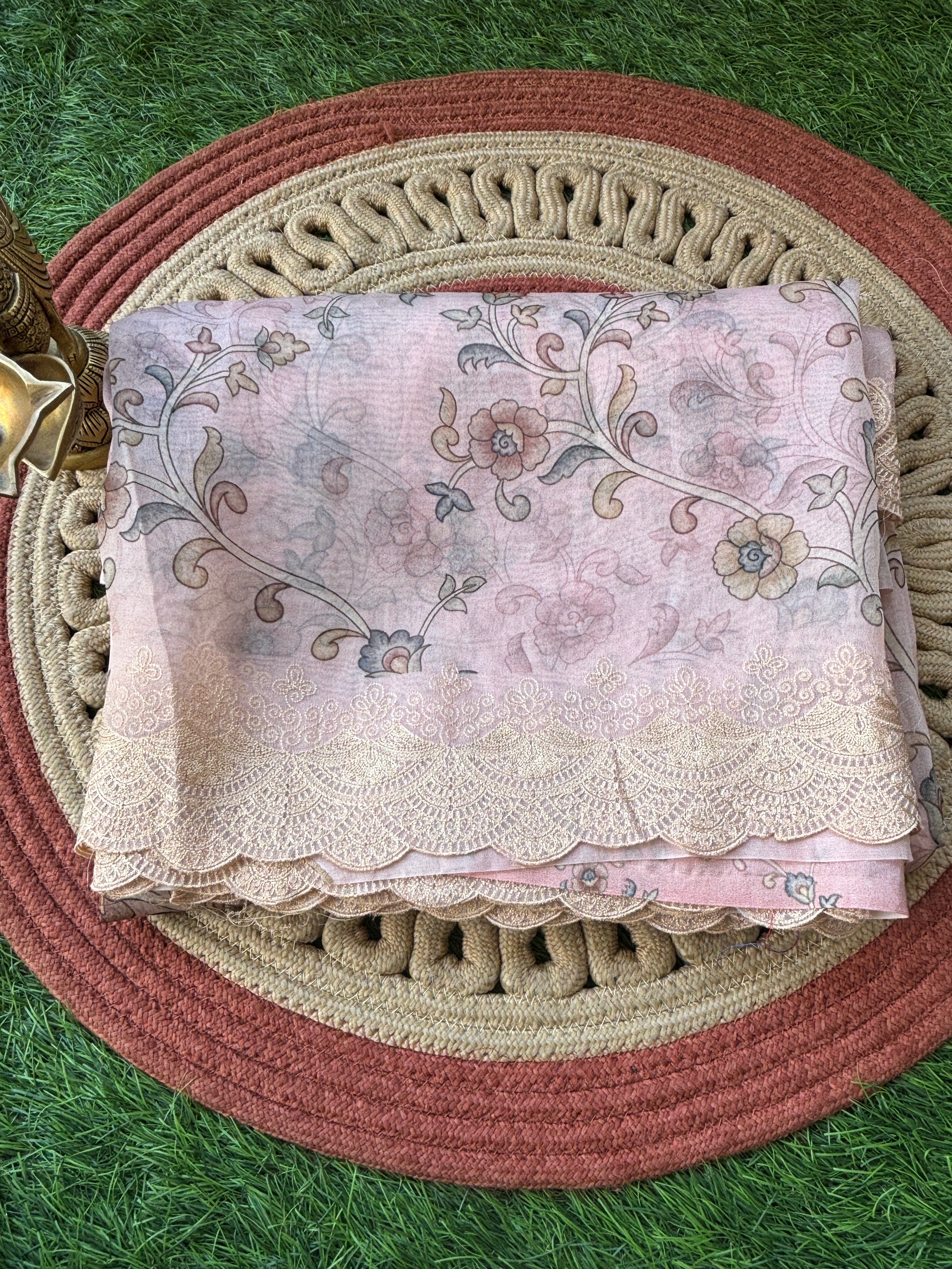 Close-up of pastel pink pure organza fabric with floral digital print showcasing lightweight sheer texture and premium finish
