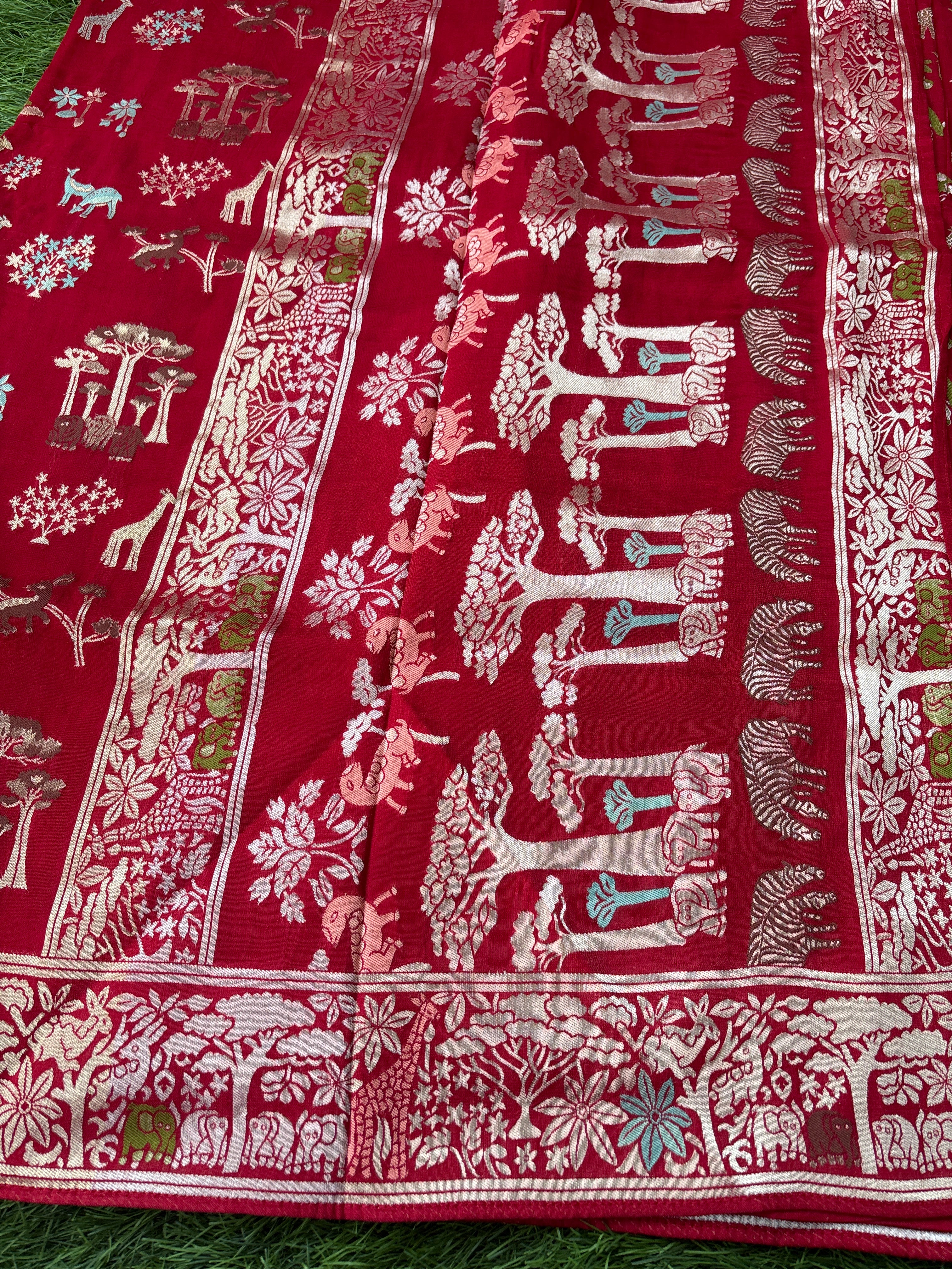  A beautiful pallu in Red fabric with intricate white patterns . Animal figure with zari work