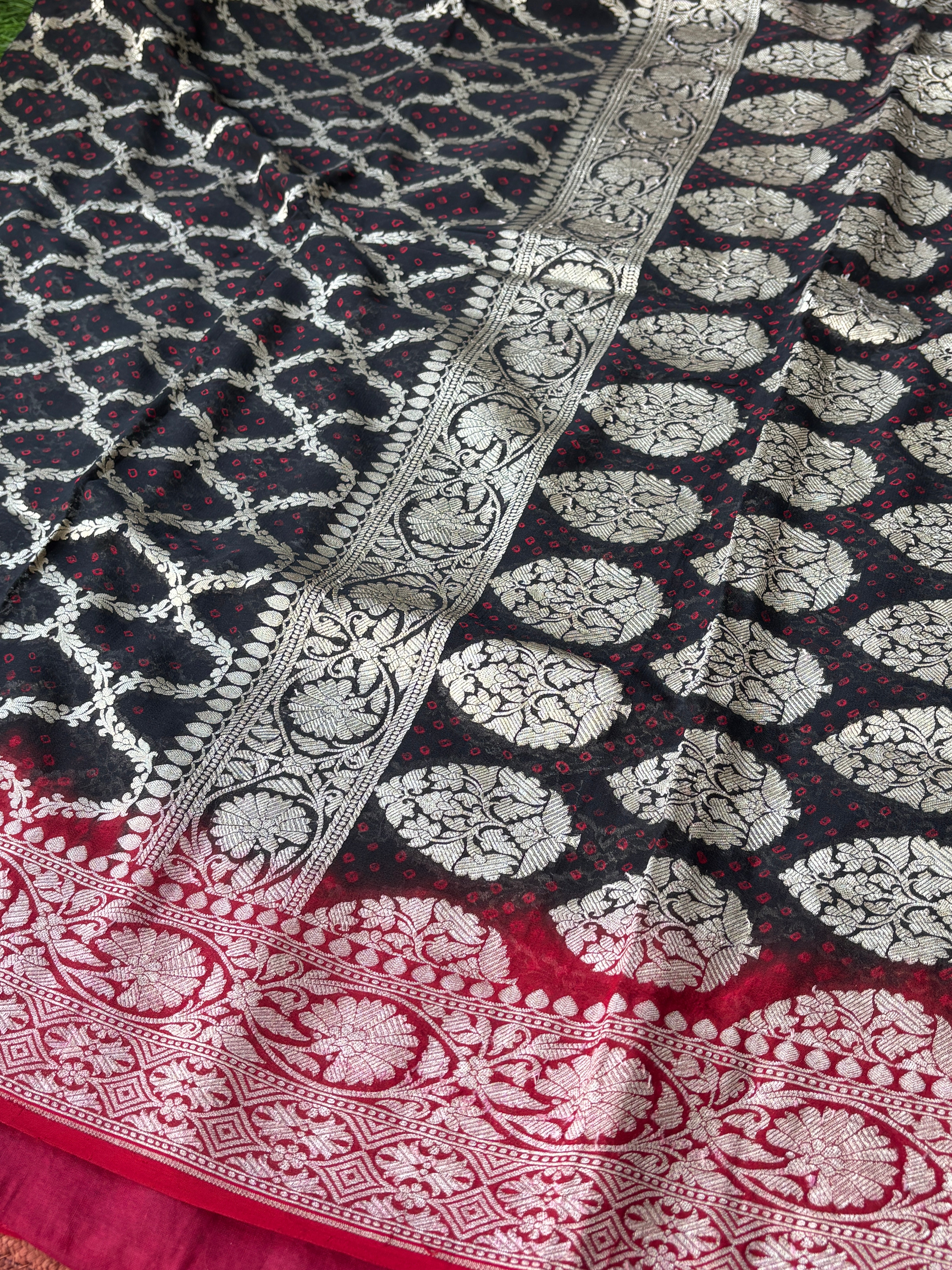 Close-up of golden zari woven motifs on black pure Khaddi Georgette Banarasi saree