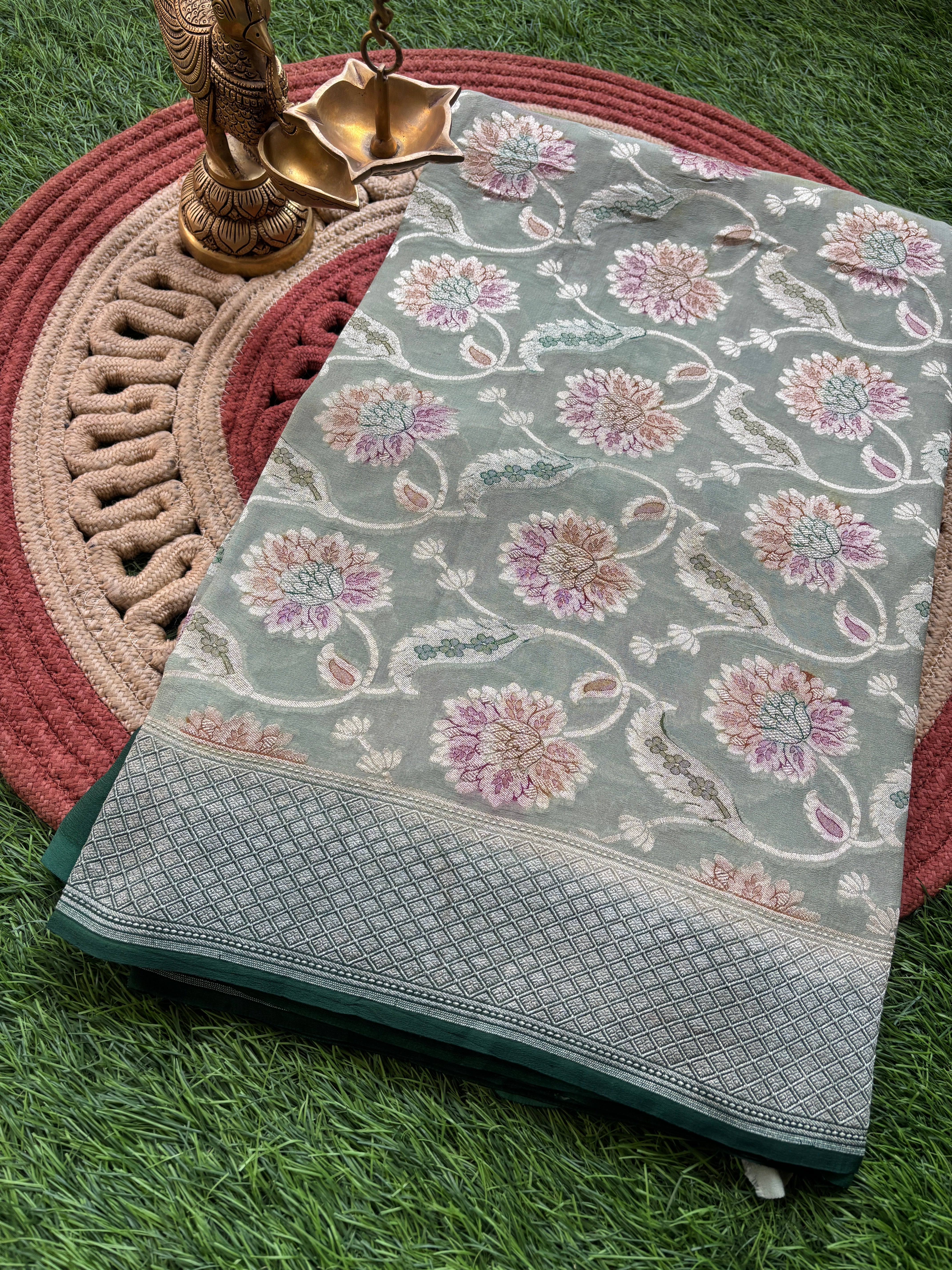 Pure khaddi georgette Banarasi saree in pastel pista green with zari weaving
