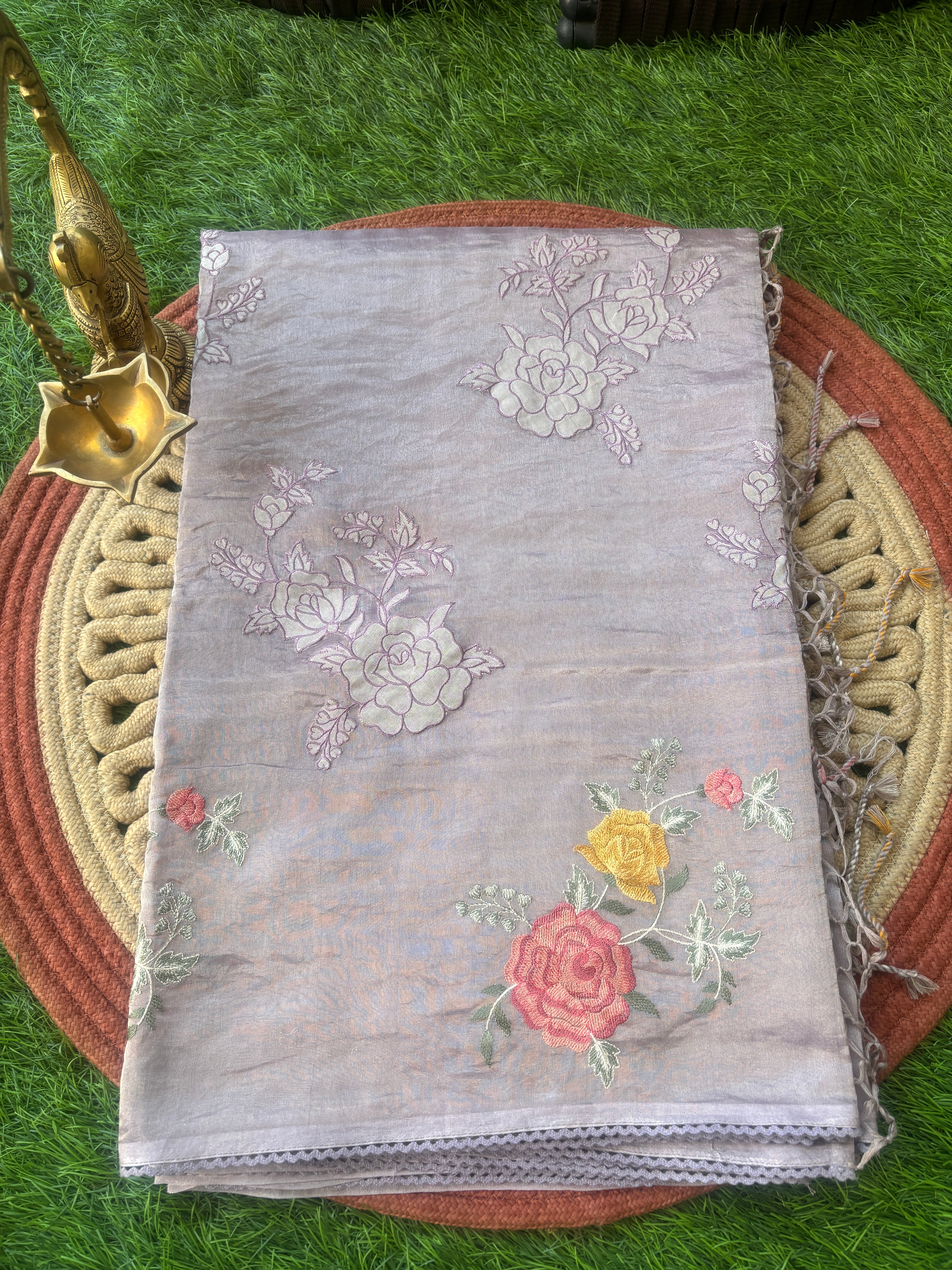 Elegant pastel purple organza saree with delicate floral embroidery and rich texture