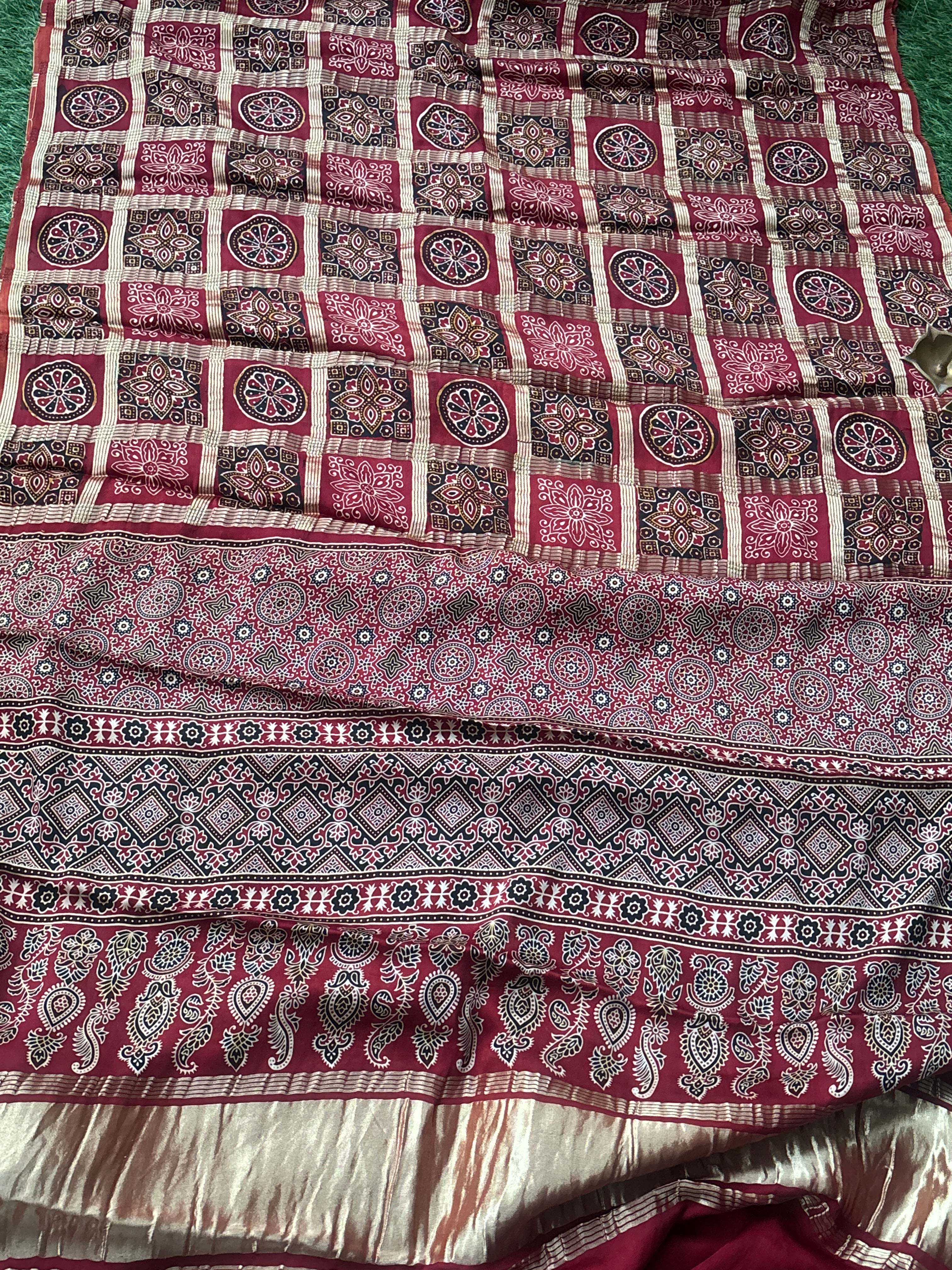 Zari woven pallu of Red Pure Modal Silk Gharchola Saree, showing intricate golden motifs