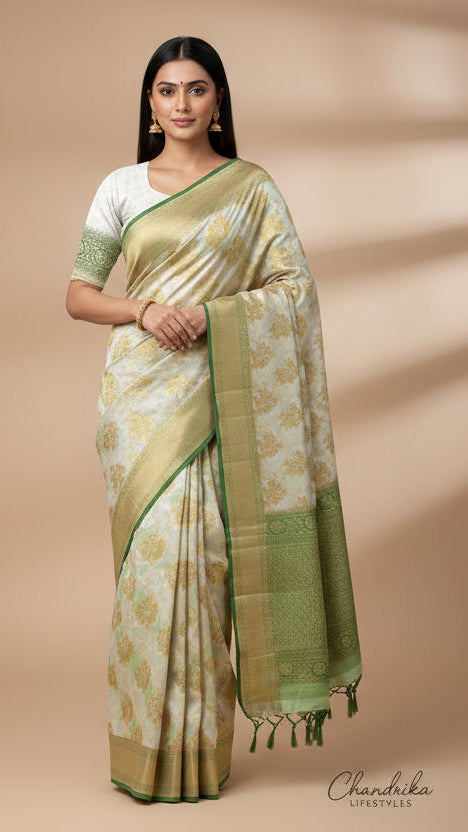 Woman wearing a green and white saree with a beige background
